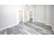 Bright bedroom featuring light gray walls and modern gray vinyl plank flooring at 2302 Rayecliff Ln, Charlotte, NC 28214
