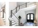 Welcoming foyer with a staircase featuring a gray handrail, and a black front door at 2302 Rayecliff Ln, Charlotte, NC 28214