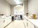 Bright hallway features white cabinets, countertops, and opens up to living and dining areas, enhancing its spacious feel at 2302 Rayecliff Ln, Charlotte, NC 28214