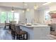 Modern kitchen featuring a large island with bar seating, stainless steel appliances, and an adjacent dining area at 2302 Rayecliff Ln, Charlotte, NC 28214