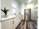 Pantry with cabinets, countertop, sink, stainless steel refrigerator and wire shelving at 2302 Rayecliff Ln, Charlotte, NC 28214