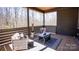 Comfortable covered porch with wicker furniture, area rug, and wooded view at 2302 Rayecliff Ln, Charlotte, NC 28214