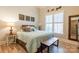 Inviting bedroom with natural light, laminate wood floors and decorative art at 258 Ridge Reserve Dr, Lake Wylie, SC 29710