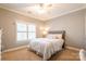 Cozy bedroom featuring neutral colors, a plush bed, and a window with natural light at 258 Ridge Reserve Dr, Lake Wylie, SC 29710