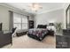 Comfortable bedroom with a ceiling fan, neutral walls, and a large window with blinds at 258 Ridge Reserve Dr, Lake Wylie, SC 29710