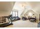 Expansive bonus room with a treadmill, comfortable seating, and twin beds at 258 Ridge Reserve Dr, Lake Wylie, SC 29710
