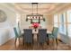 Formal dining room with stylish light fixture, hardwood floors, and elegant wainscoting at 258 Ridge Reserve Dr, Lake Wylie, SC 29710