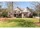 Charming home with stone accents, red shutters, and a well-manicured lawn creating a welcoming curb appeal at 258 Ridge Reserve Dr, Lake Wylie, SC 29710