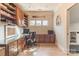 Well-lit home office features custom built-ins, glass desk, and hardwood floors at 258 Ridge Reserve Dr, Lake Wylie, SC 29710