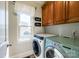 Convenient laundry room featuring modern washer and dryer units and a window at 258 Ridge Reserve Dr, Lake Wylie, SC 29710