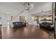 Open living room showcasing hardwood floors, modern decor, staircase, and seamless flow into kitchen at 2808 Thornbush Ct, Charlotte, NC 28270