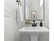Bright bathroom featuring a white pedestal sink with black hardware at 3202 Riley Ave, Charlotte, NC 28269