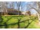 Large backyard with green grass, mature trees, and fenced perimeter at 3428 Braewick Pl, Charlotte, NC 28227