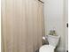 Cozy bathroom featuring toilet with cream colored shower curtain at 3428 Braewick Pl, Charlotte, NC 28227