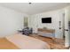 Bright bedroom with hardwood floors, modern dresser, TV, and changing table offers a comfortable space at 3428 Braewick Pl, Charlotte, NC 28227