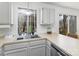 Bright kitchen featuring a stainless steel sink and cabinets, complemented by a window view and sliding door to outside at 3428 Braewick Pl, Charlotte, NC 28227