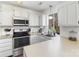 Well-appointed kitchen featuring modern appliances, ample counter space, and a window offering natural light, ideal for cooking at 3428 Braewick Pl, Charlotte, NC 28227