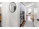 Bright laundry room with modern washer and dryer, shelving and view to the side yard at 3428 Braewick Pl, Charlotte, NC 28227