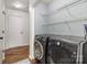 Laundry room features modern machines, wire rack shelving and access to side yard at 3428 Braewick Pl, Charlotte, NC 28227