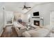 Bright living room boasts a fireplace, ceiling fan, and seamless flow to the dining area, perfect for modern living at 3428 Braewick Pl, Charlotte, NC 28227