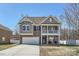 Charming two-story home featuring a covered porch, balcony, and attached two-car garage at 3619 Martele Dr # 55, Charlotte, NC 28227