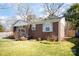 Brick home with a green lawn, walkway to the entrance, and decorative shutters on the windows at 4115 Greenhaven Ln, Charlotte, NC 28205