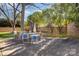 Outdoor patio area featuring a dining set, seating, privacy fence, and shade trees for relaxation at 4115 Greenhaven Ln, Charlotte, NC 28205