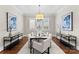 Formal dining room features a modern chandelier, neutral paint, and large windows at 416 Eli St, Charlotte, NC 28204