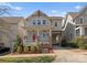 Charming two-story home with a welcoming front porch, red door and well-manicured landscaping at 416 Eli St, Charlotte, NC 28204