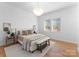 Cozy bedroom featuring a comfortable bed with decorative pillows, a stylish light fixture, and a relaxing atmosphere at 4207 Walker Rd, Charlotte, NC 28211