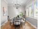 Elegant dining room with stylish chandelier, hardwood floors, and large windows, perfect for gatherings at 4207 Walker Rd, Charlotte, NC 28211