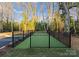 Private dog park featuring an enclosed area with artificial turf, nestled among trees and greenery at 4207 Walker Rd, Charlotte, NC 28211