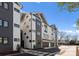 Modern townhome showcasing unique architecture, multiple windows, and attached garage spaces at 4207 Walker Rd, Charlotte, NC 28211