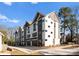 Modern townhouse exterior featuring two-tone color scheme and attached garages at 4207 Walker Rd, Charlotte, NC 28211