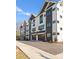 Contemporary townhome featuring a two-tone facade, individual garages, and a private driveway at 4207 Walker Rd, Charlotte, NC 28211
