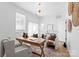 Well-lit home office with a rustic wood desk, comfortable seating, and a calming atmosphere for work at 4207 Walker Rd, Charlotte, NC 28211