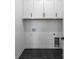 Practical laundry room with white cabinets, tile floor, and washer/dryer hookups at 4207 Walker Rd, Charlotte, NC 28211