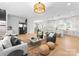 Bright, open-concept living room flowing into a modern kitchen with light hardwood floors and stylish decor at 4207 Walker Rd, Charlotte, NC 28211