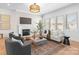 Cozy living room featuring a fireplace, large windows, and neutral tones that create a relaxing atmosphere at 4207 Walker Rd, Charlotte, NC 28211