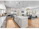 Bright living room with open concept kitchen, fireplace, and hardwood floors at 4207 Walker Rd, Charlotte, NC 28211