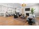 Open-concept living room and kitchen featuring hardwood floors, fireplace, and modern decor at 4207 Walker Rd, Charlotte, NC 28211