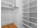 Organized walk-in closet with custom shelving and ample storage space, offering a practical solution at 4207 Walker Rd, Charlotte, NC 28211
