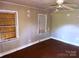 Bedroom with paneled windows, hardwood floors, a ceiling fan, and walls that need repair at 437 & 437 1/2 Hope St, Rock Hill, SC 29730