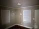 Bedroom with paneled window, bare walls needing repair, and worn trim awaiting renovation at 437 & 437 1/2 Hope St, Rock Hill, SC 29730