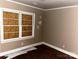 Bedroom with paneled window, bare walls that need repair, and damaged trim in need of TLC at 437 & 437 1/2 Hope St, Rock Hill, SC 29730