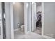 Bathroom featuring a toilet, and a doorway to a carpeted walk-in closet at 5050 Watersail Way, Lake Wylie, SC 29710