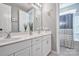 Bright bathroom with double vanity, white cabinets, marble countertops, and decorative accents at 5050 Watersail Way, Lake Wylie, SC 29710