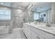 Bright bathroom with double vanity, white cabinets, marble countertops, and glass enclosed shower and tub at 5050 Watersail Way, Lake Wylie, SC 29710