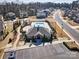 Aerial view of the community clubhouse, featuring a pool, playground, and parking area for resident enjoyment at 5050 Watersail Way, Lake Wylie, SC 29710
