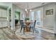 Cozy dining area with a round wooden table, stylish chairs, and natural light from the French doors at 5050 Watersail Way, Lake Wylie, SC 29710